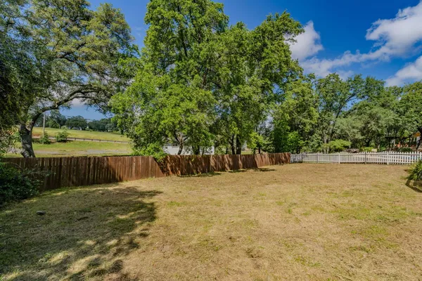 aerial view of a house with a yard and a fountain