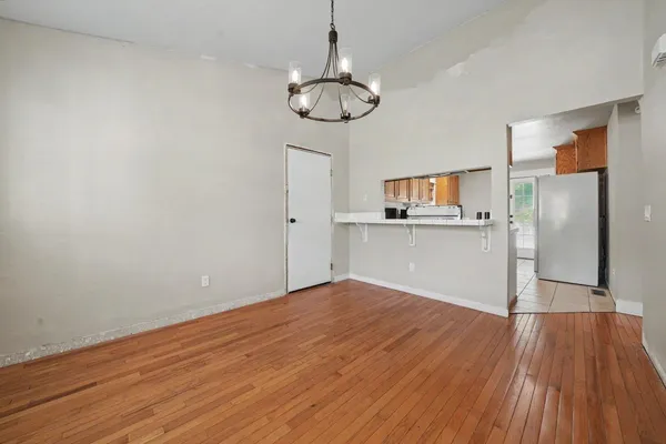 a view of a kitchen with wooden floor and a kitchen