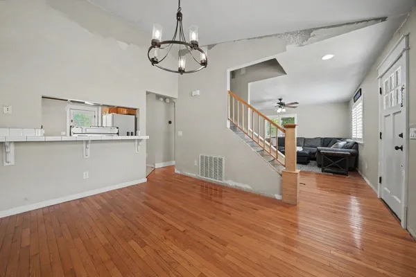 a view of a room with wooden floor and staircase