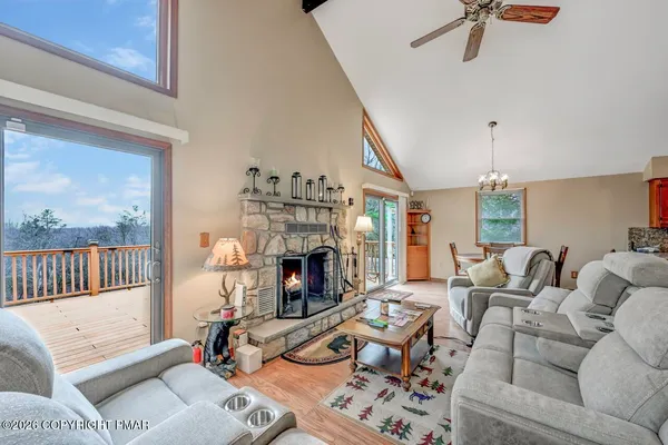 a living room with furniture fireplace and a chandelier