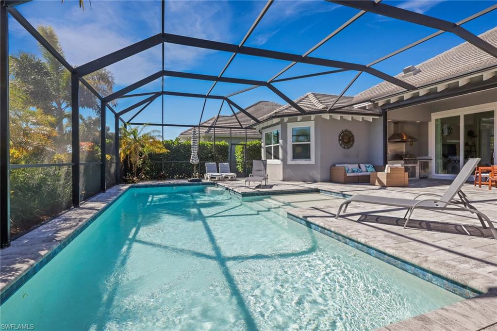 6394 Warwick Avenue Naples, FL 34113 - Photo 13 of 30 a view of a chair and tables in the patio