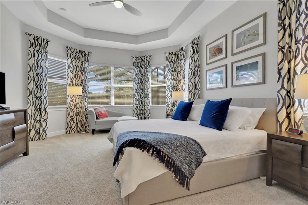 6394 Warwick Avenue Naples, FL 34113 - Photo 14 of 30 a spacious bedroom with a bed couch and a window