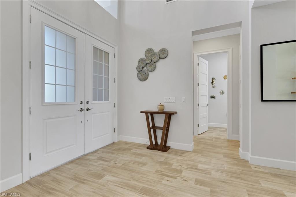 6394 Warwick Avenue Naples, FL 34113 - Photo 2 of 30 wooden floor in an empty room