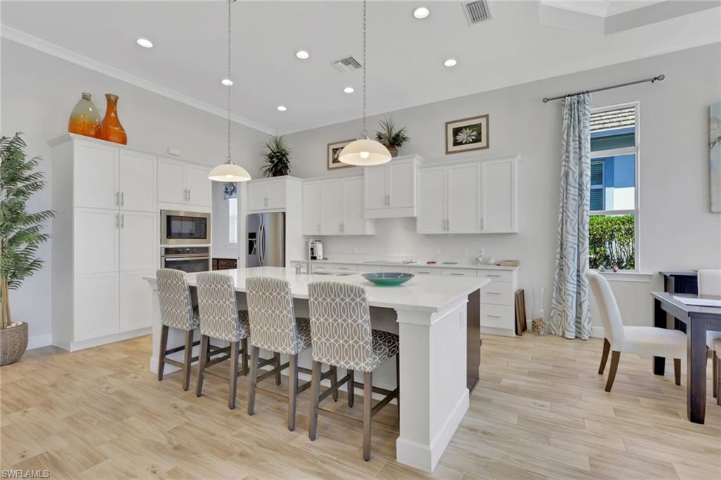 6394 Warwick Avenue Naples, FL 34113 - Photo 5 of 30 a large kitchen with a table and chairs in it