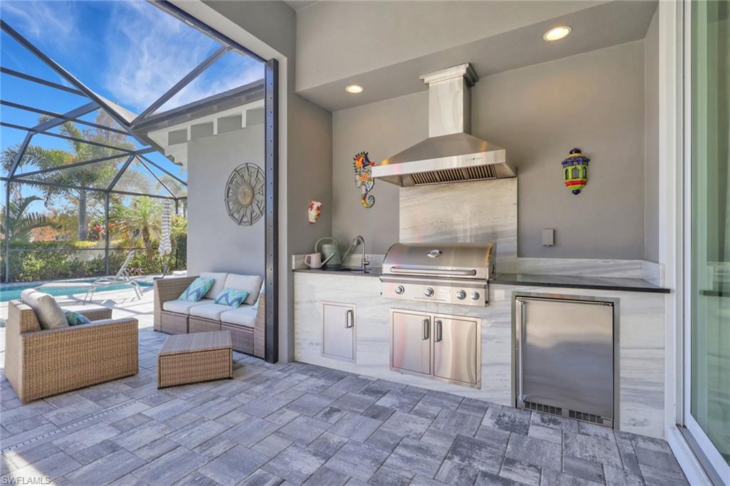 6394 Warwick Avenue Naples, FL 34113 - Photo 10 of 30 a kitchen with stainless steel appliances granite countertop a stove a sink and a refrigerator
