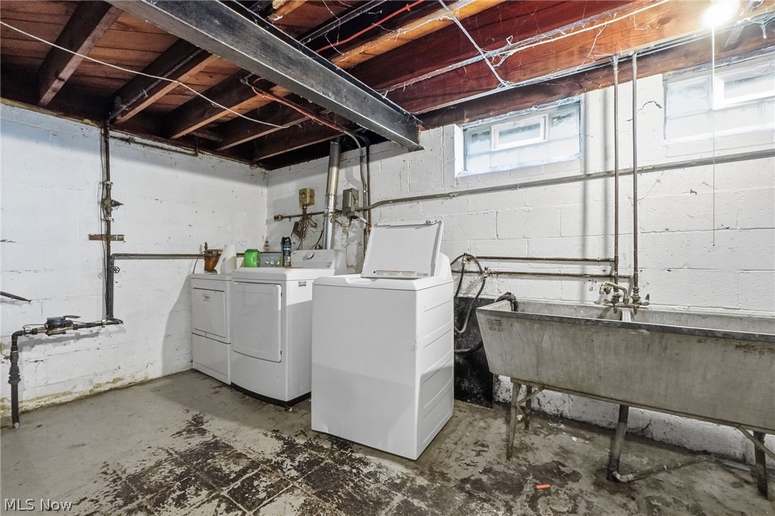 2537 Edgewood Road Beachwood, OH 44122 - Photo 35 of 39 Basement laundry area featuring exposed wood joists, block walls, concrete flooring, and a utility sink