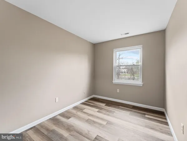 a view of an empty room and wooden floor