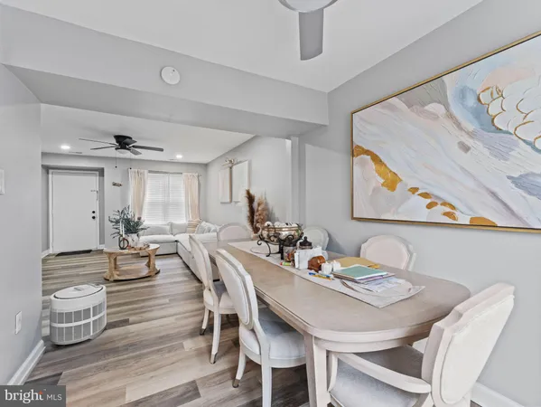a kitchen with stainless steel appliances granite countertop a refrigerator a sink dishwasher a stove and white countertops with wooden floor