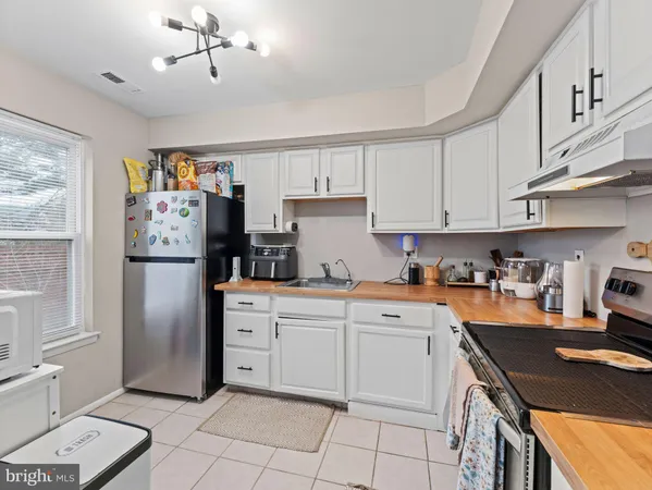 a kitchen with a stove top oven and cabinets