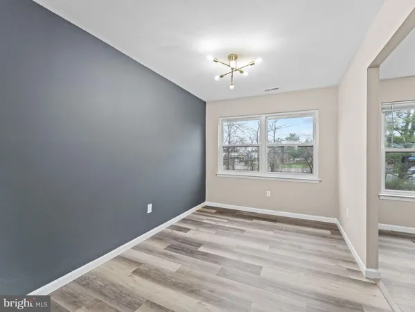 an empty room with windows and closet