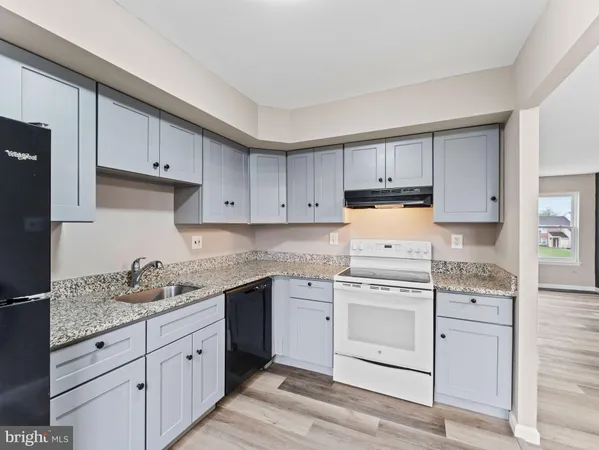 a kitchen with a refrigerator and window