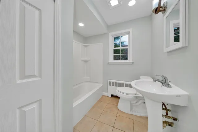 a bathroom with a sink a toilet and bathtub