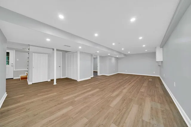 a view of an empty room with wooden floor