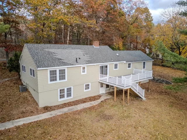 an aerial view of a house with table and chairs