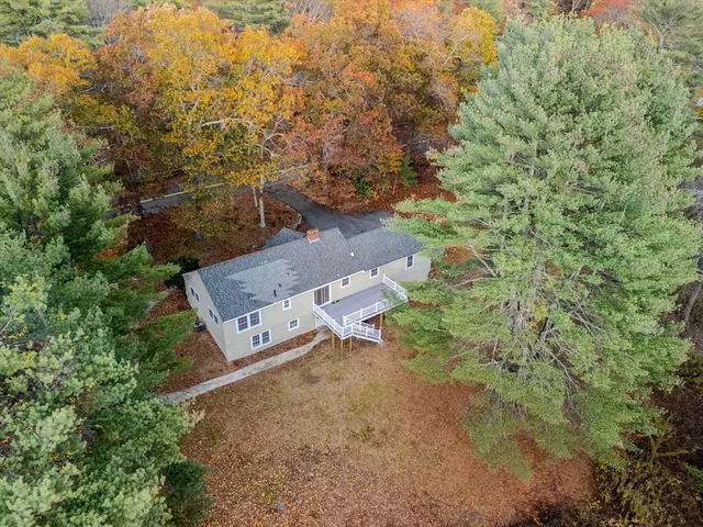 an aerial view of a house with a yard
