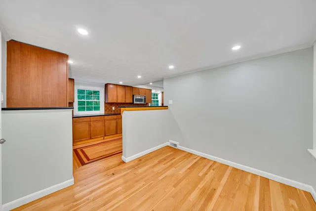 a view of a room with wooden floor and cabinet