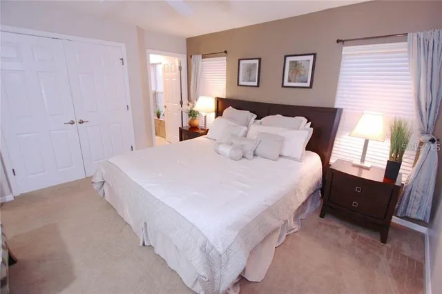 a spacious bedroom with a bed and a tv