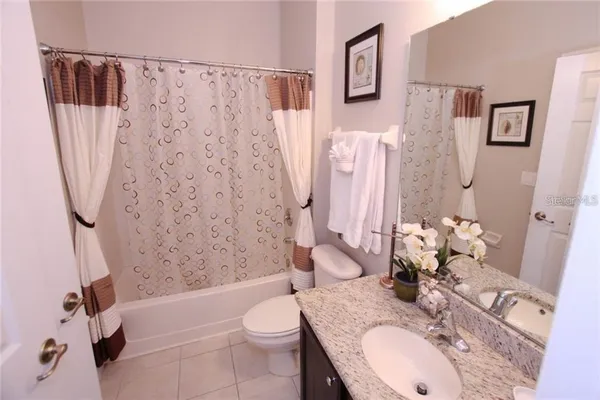 a bath room with a sink toilet and shower