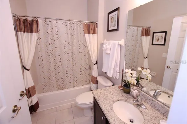 a bath room with a sink toilet and shower