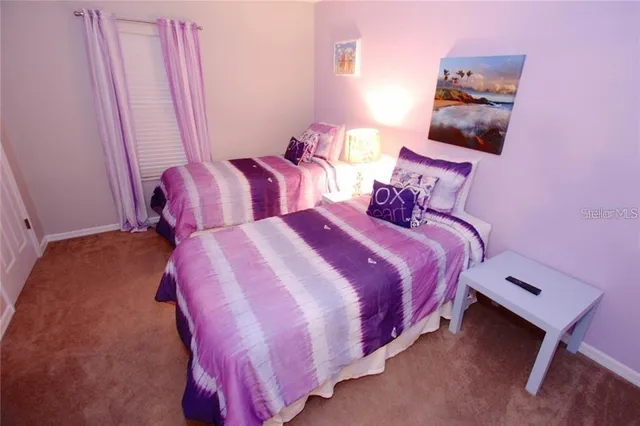 a bedroom with a bed and with furniture