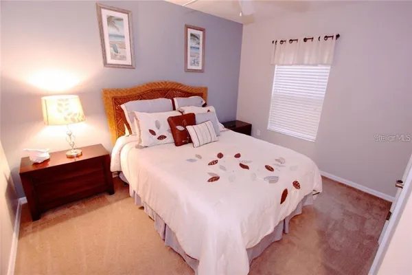 a bed sitting in a bedroom next to a window