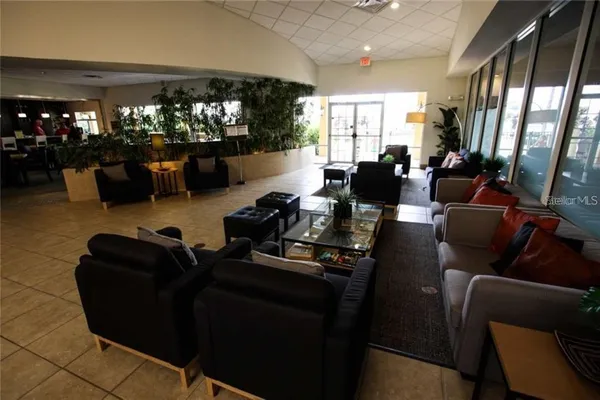 a living room with furniture hard wood floor and windows