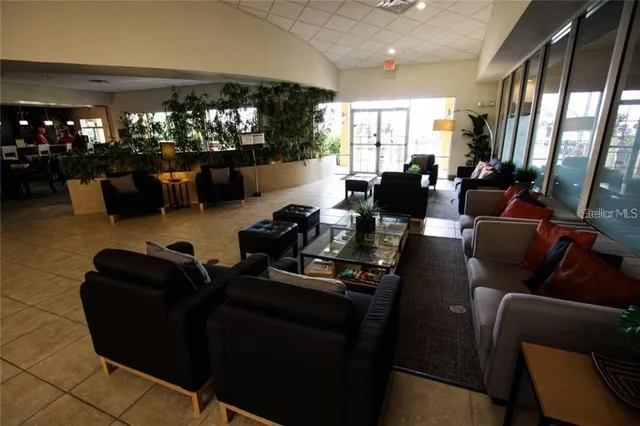 a living room with furniture hard wood floor and windows