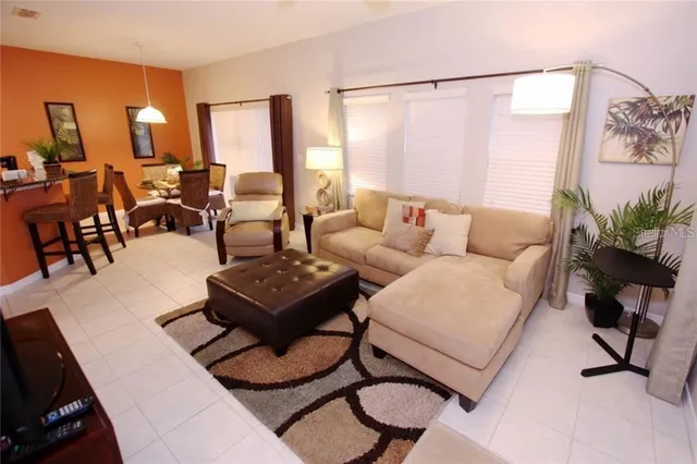 a living room with furniture and floor to ceiling window