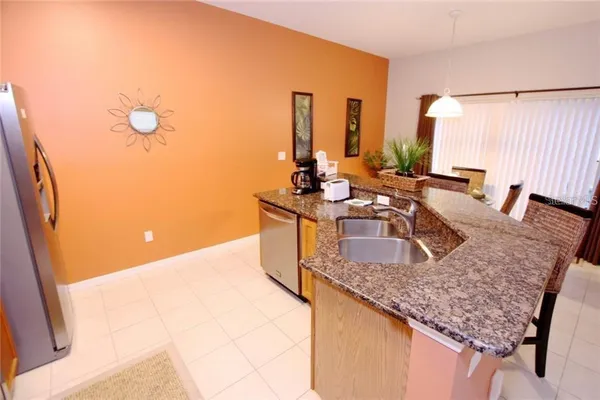 a kitchen with granite countertop a sink and a stove