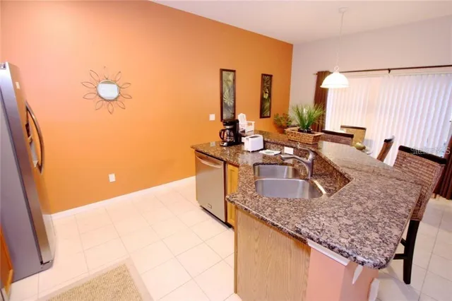 a kitchen with granite countertop a sink and a stove