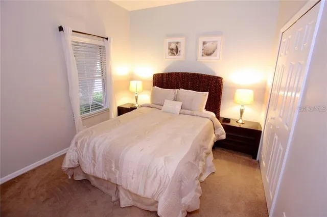 a bedroom with a bed and window