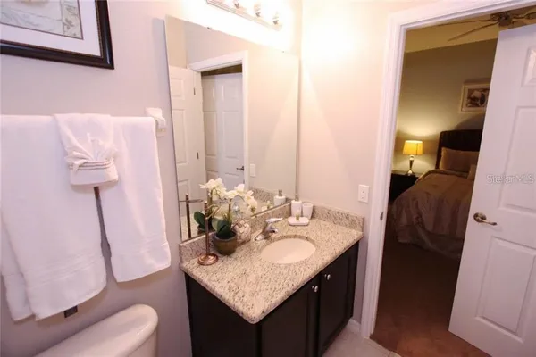 a bathroom with a granite countertop sink and a mirror
