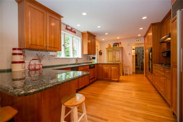 2 Clark Road Wellesley, MA 02481 - Photo 11 of 16 a large kitchen with stainless steel appliances granite countertop a sink and cabinets