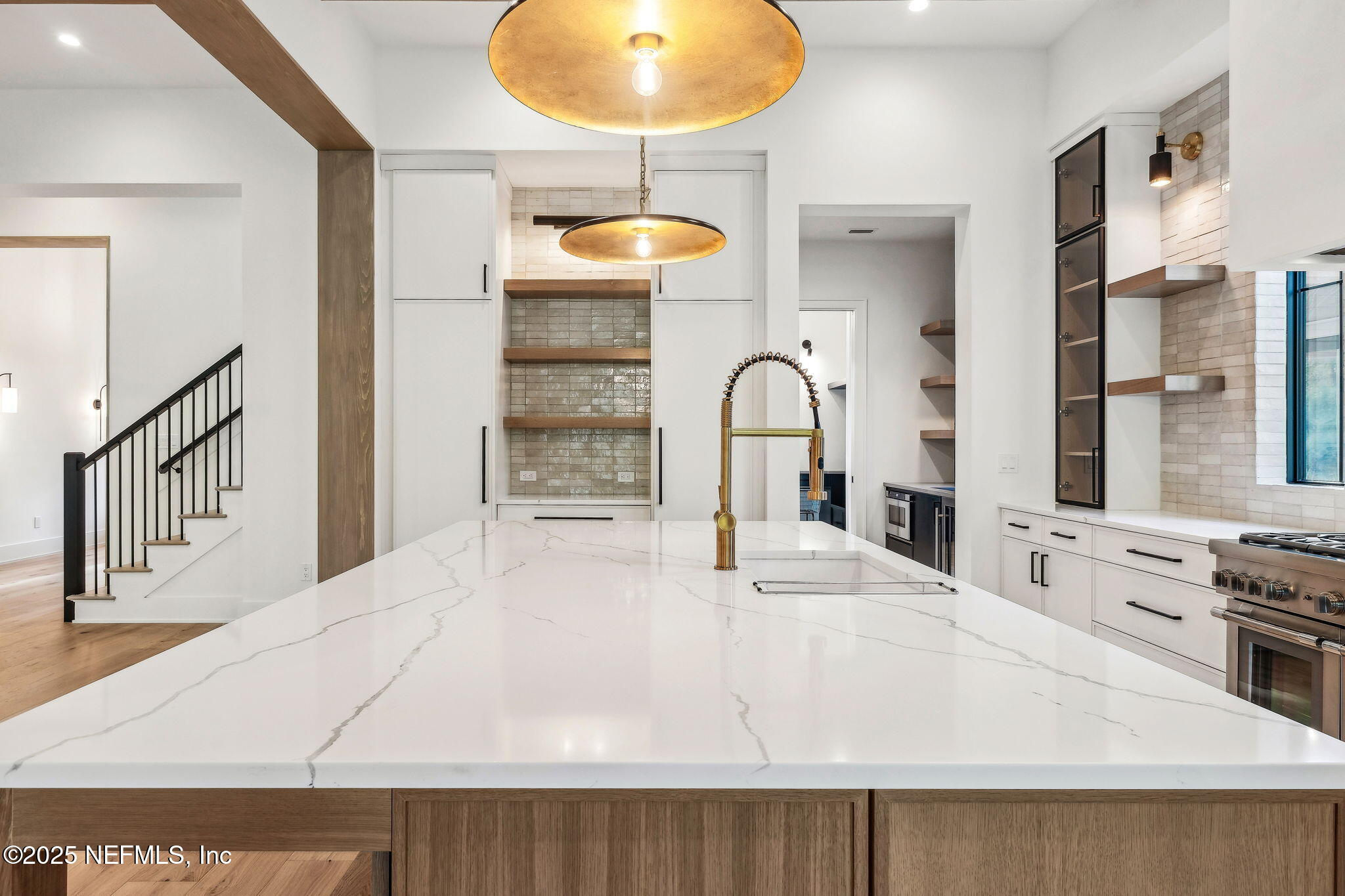 4650 Palm Valley Road Ponte Vedra Beach, FL 32082 - Photo 17 of 80 a view of a kitchen with a stove and white cabinets