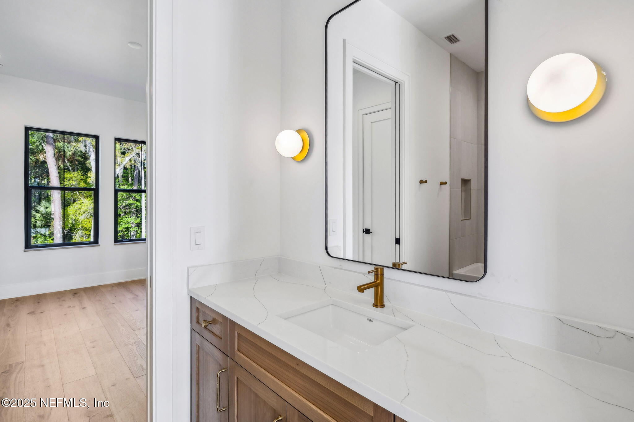 4650 Palm Valley Road Ponte Vedra Beach, FL 32082 - Photo 44 of 80 a bathroom with a sink and a mirror