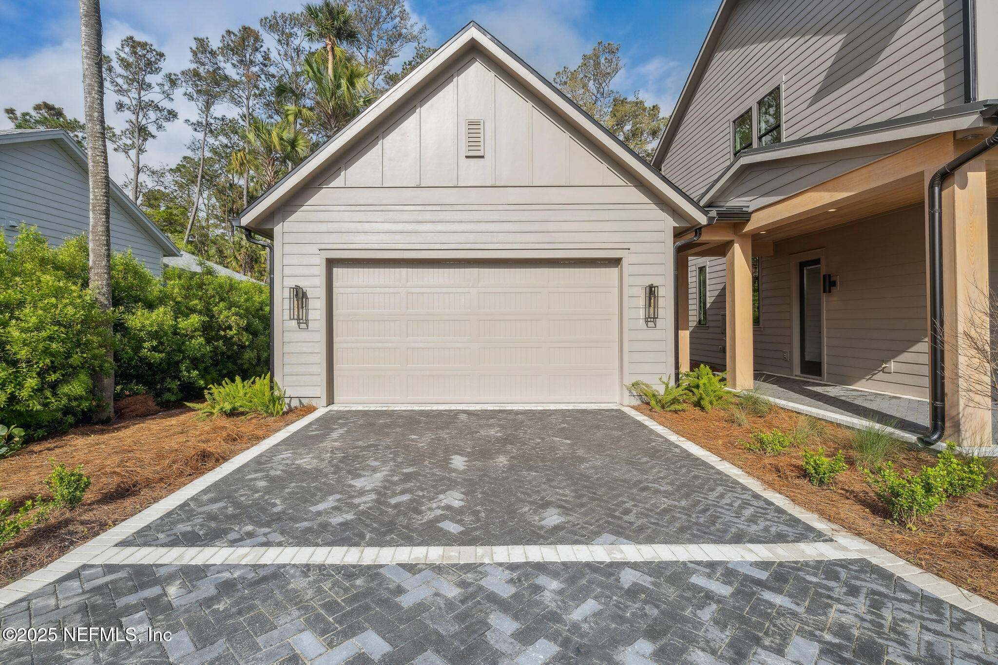 4650 Palm Valley Road Ponte Vedra Beach, FL 32082 - Photo 6 of 80 a view of a white house with a large space potted plants in front of main door