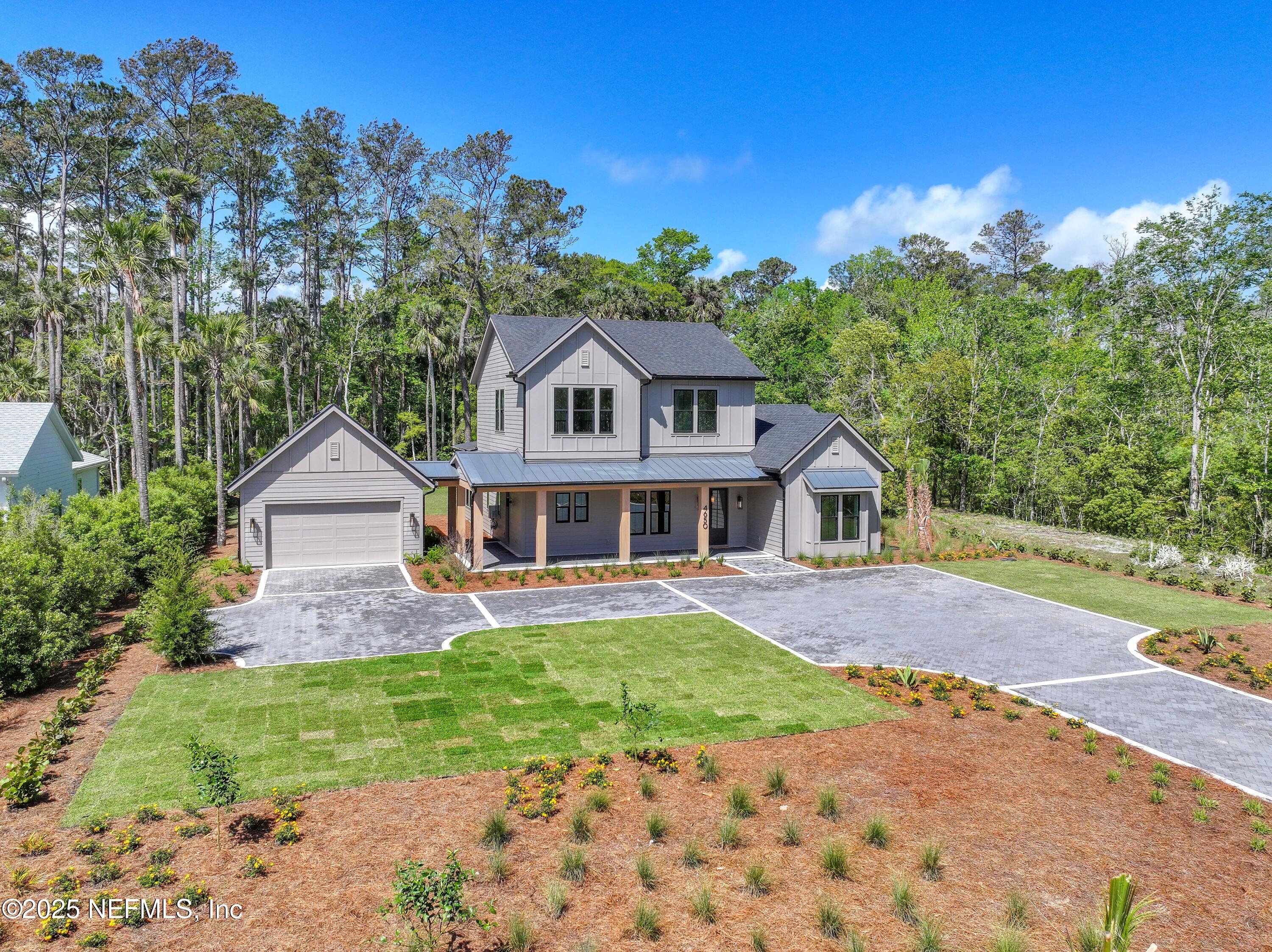 4650 Palm Valley Road Ponte Vedra Beach, FL 32082 - Photo 78 of 80 a front view of a house with a garden and yard