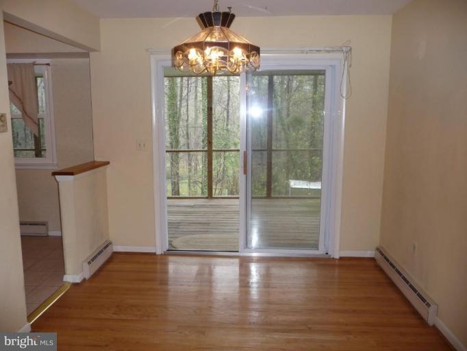 3074 Tudor Hall Road Riva, MD 21140 - Photo 4 of 13 wooden floor in an empty room with a window