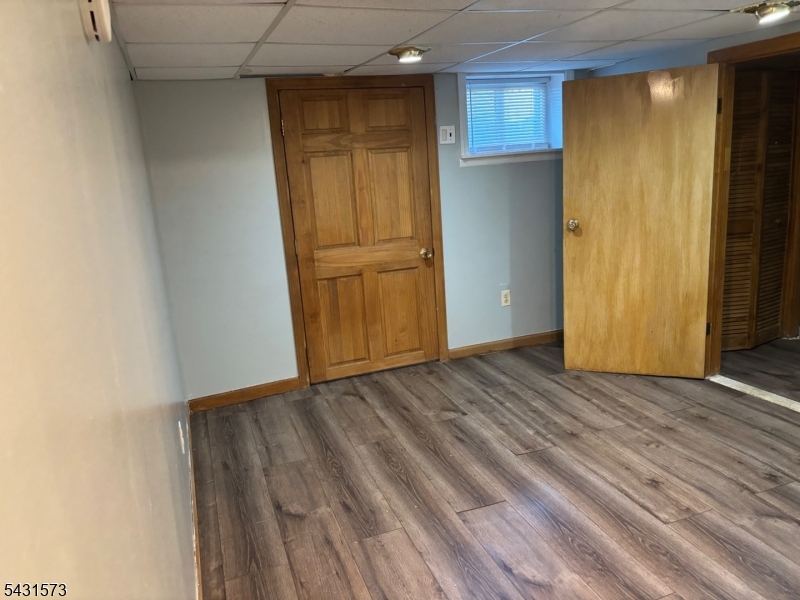 358 Woodland Road, Unit 2 Madison, NJ 07940 - Photo 39 of 50 a view of an empty room with wooden floor and a window