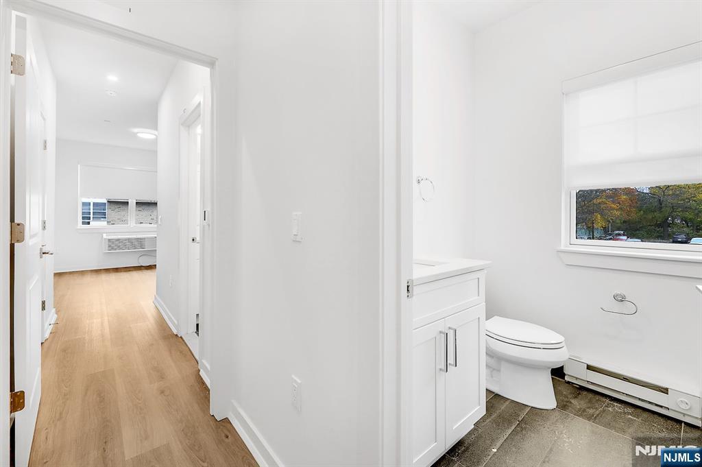 74 Clarendon Place, Unit 202 Hackensack, NJ 07601 - Photo 17 of 32 a bathroom with a sink and a toilet