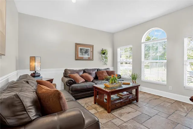 a living room with furniture and a large window