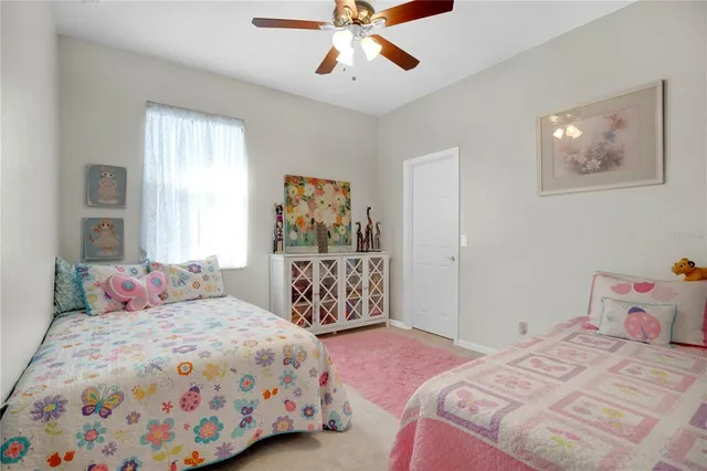 a bedroom with a bed and painting on the wall