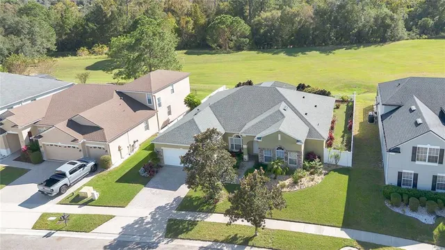 an aerial view of a house with garden space and lake view