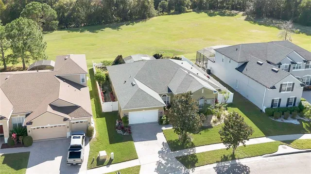 an aerial view of residential houses with outdoor space and swimming pool