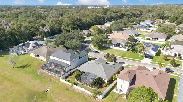 an aerial view of a house with a yard