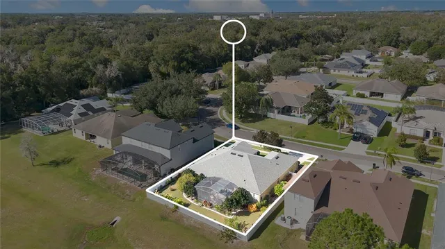 an aerial view of a house with a yard