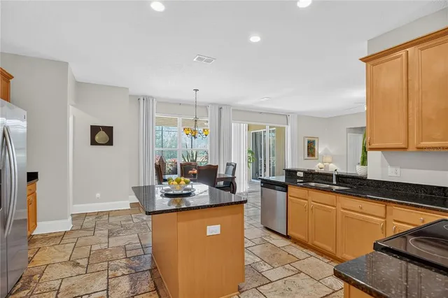 a kitchen with granite countertop a sink and cabinets