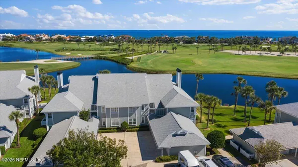 an aerial view of a house with a ocean view