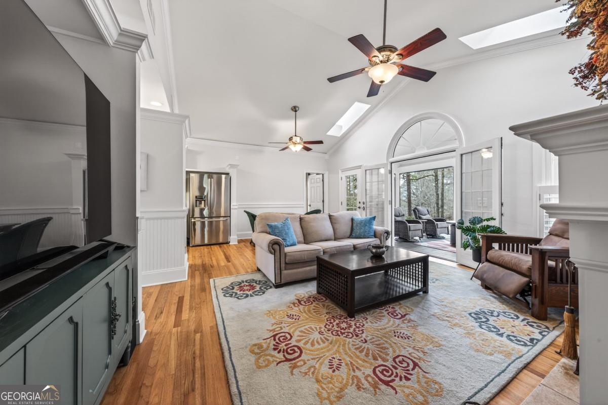 1091 Maple Ridge Way Greensboro, GA 30642 - Photo 12 of 52 a living room with furniture fireplace and a chandelier