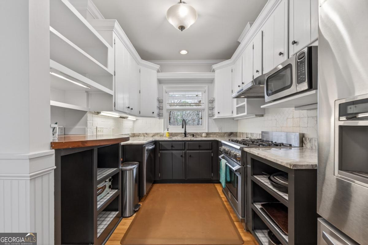1091 Maple Ridge Way Greensboro, GA 30642 - Photo 15 of 52 a kitchen with stainless steel appliances granite countertop a sink and stove top oven